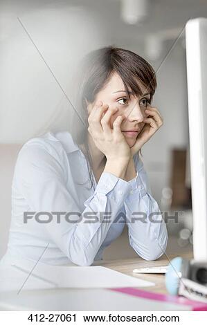 Frustrated brunette businesswoman working at computer in office View Large Photo Image Stock Image - Frustrated brunette businesswoman working at computer in office. Fotosearch