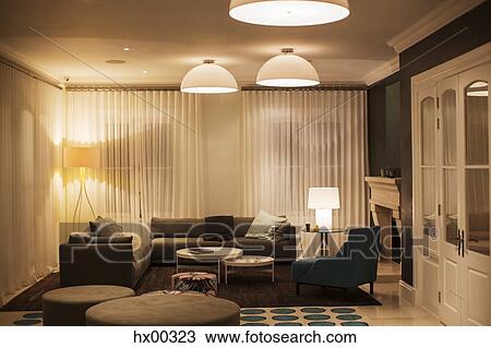 Stock Image - Illuminated domed lights over home showcase living room. Fotosearch