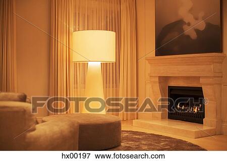 Illuminated floor lamp next to marble fireplace View Large Photo Image Stock Photo - Illuminated floor lamp next to marble fireplace. Fotosearch