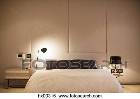 Illuminated lamp over bed View Large Photo Image Stock Photograph - Illuminated lamp over bed. Fotosearch