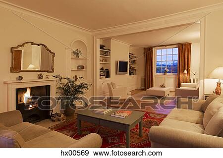 Illuminated living room with fireplace View Large Photo Image Stock Photo - Illuminated living room with fireplace. Fotosearch