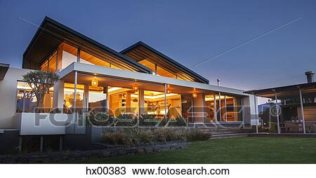 Illuminated luxury modern house at night View Large Photo Image Stock Image - Illuminated luxury modern house at night. Fotosearch