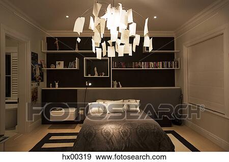 Illuminated modern paper chandelier hanging in bedroom View Large Photo Image Stock Photo - Illuminated modern paper chandelier hanging in bedroom. Fotosearch