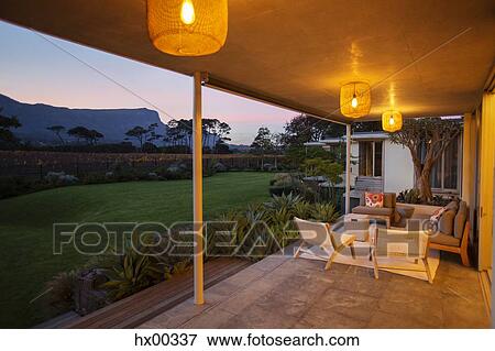 Illuminated patio overlooking mountains at dusk View Large Photo Image Stock Photo - Illuminated patio overlooking mountains at dusk. Fotosearch