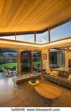 Illuminated wood ceiling over luxury living room open to patio View Large Photo Image Stock Photograph - Illuminated wood ceiling over luxury living room open to patio. Fotosearch