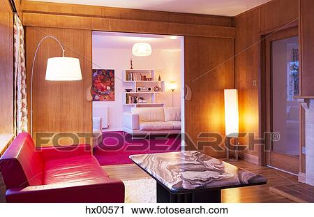 Stock Image - Illuminated wood paneled living room. Fotosearch