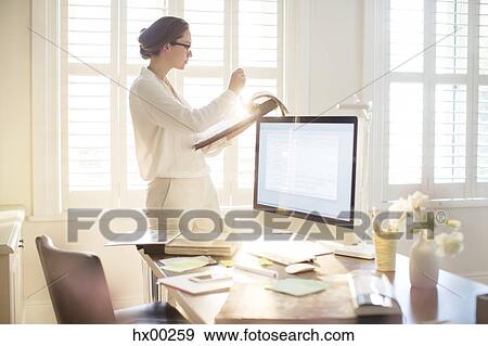 Interior designer looking at swatches in sunny home office View Large Photo Image Stock Photo - Interior designer looking at swatches in sunny home office. Fotosearch