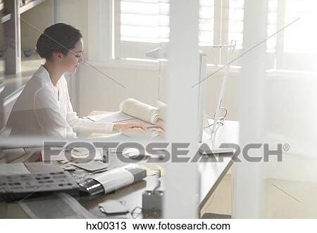 Interior designer working at computer in home office View Large Photo Image Stock Image - Interior designer working at computer in home office. Fotosearch