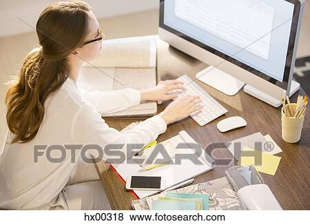 Interior designer working at computer in home office View Large Photo Image Stock Photo - Interior designer working at computer in home office. Fotosearch
