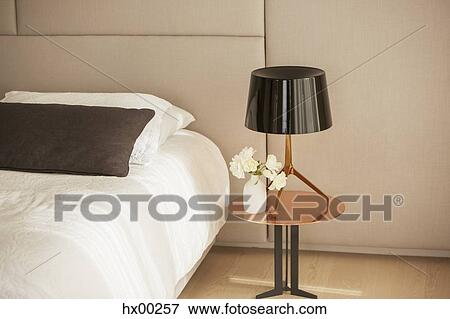 Lamp and rose bouquet on bedside table View Large Photo Image Stock Photo - Lamp and rose bouquet on bedside table. Fotosearch