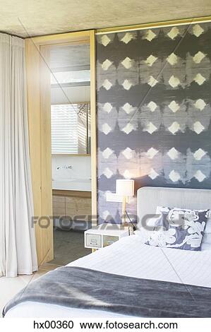 Lamp on bedside table in gray and white bedroom View Large Photo Image Stock Image - Lamp on bedside table in gray and white bedroom. Fotosearch
