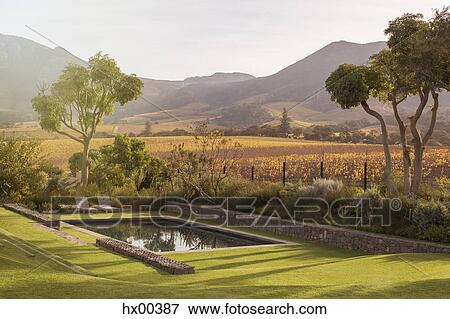 Stock Photo - Landscape view of fields and mountains behind swimming pool. Fotosearch