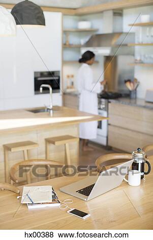 Laptop, French press coffee, cell phone and notebook on kitchen table View Large Photo Image Stock Photo - Laptop, French press coffee, cell phone and notebook on kitchen table. Fotosearch