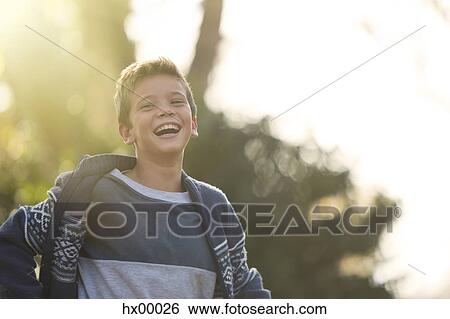 Stock Photograph - Laughing boy outdoors. Fotosearch