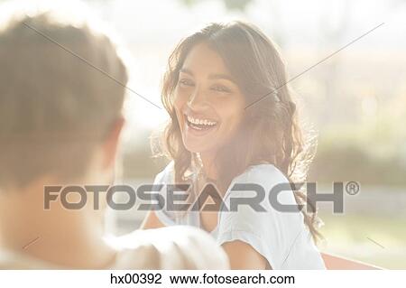 Stock Image - Laughing woman looking at man. Fotosearch