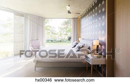 Stock Photograph - Luxury bedroom open to yard. Fotosearch
