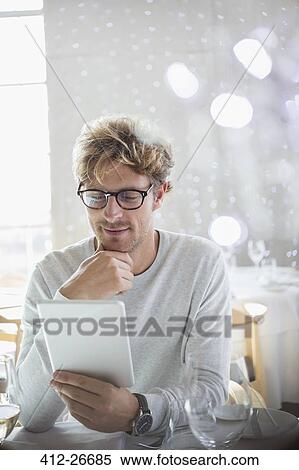 Man using digital tablet View Large Photo Image Stock Photography - Man using digital tablet. Fotosearch