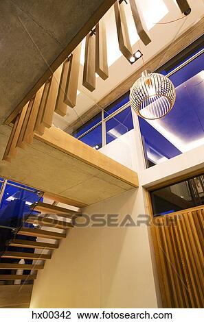 Modern pendant light and stairs in luxury foyer View Large Photo Image Stock Image - Modern pendant light and stairs in luxury foyer. Fotosearch