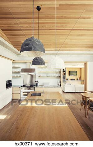 Modern pendant lights over long wood kitchen island View Large Photo Image Stock Image - Modern pendant lights over long wood kitchen island. Fotosearch
