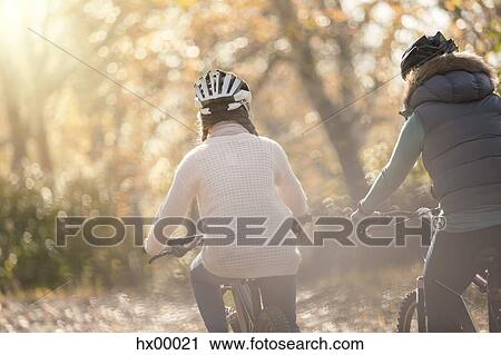 Mother and daughter bike riding in woods View Large Photo Image Stock Image - Mother and daughter bike riding in woods. Fotosearch