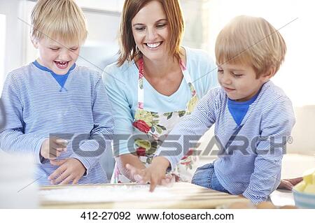 Mother and sons baking in kitchen View Large Photo Image Stock Image - Mother and sons baking in kitchen. Fotosearch