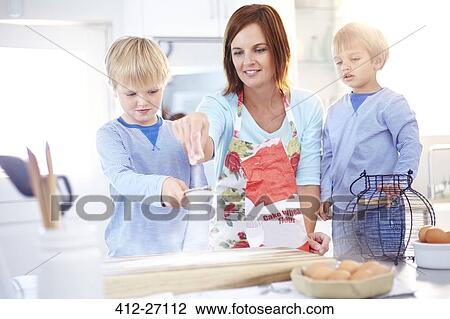 Mother and sons baking in kitchen View Large Photo Image Stock Image - Mother and sons baking in kitchen. Fotosearch