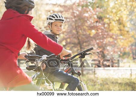 Portrait boy bike riding in autumn park View Large Photo Image Stock Photo - Portrait boy bike riding in autumn park. Fotosearch