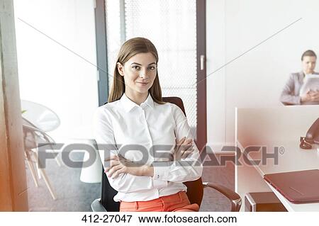 Portrait confident brunette businesswoman with arms crossed in office View Large Photo Image Stock Photo - Portrait confident brunette businesswoman with arms crossed in office. Fotosearch