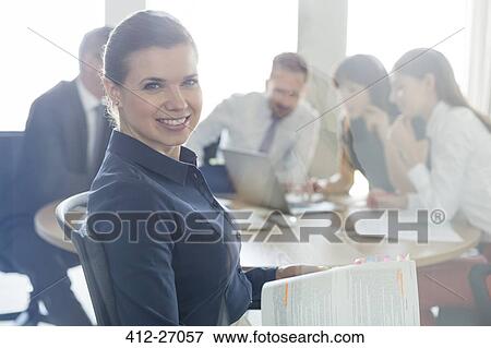 Portrait confident brunette businesswoman with report in conference room meeting View Large Photo Image Stock Photo - Portrait confident brunette businesswoman with report in conference room meeting. Fotosearch