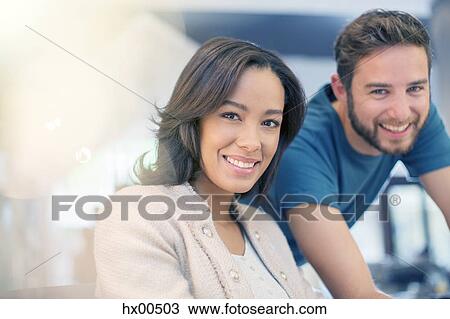 Stock Image - Portrait confident businessman and businesswoman. Fotosearch