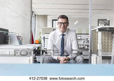 Portrait confident businessman with eyeglasses in office View Large Photo Image Stock Photo - Portrait confident businessman with eyeglasses in office. Fotosearch