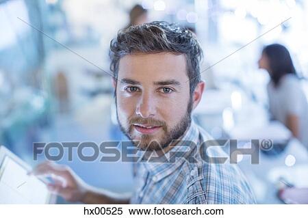 Stock Photography - Portrait confident businessman with digital tablet. Fotosearch