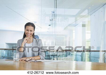Portrait confident businesswoman at conference room table View Large Photo Image Stock Image - Portrait confident businesswoman at conference room table. Fotosearch