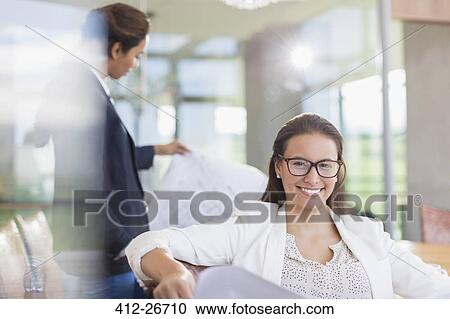 Portrait confident businesswoman in office View Large Photo Image Stock Image - Portrait confident businesswoman in office. Fotosearch