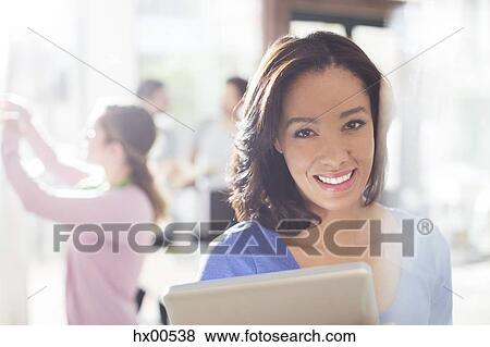 Stock Photo - Portrait confident businesswoman with digital tablet. Fotosearch