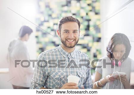 Stock Photo - Portrait confident creative businessman drinking coffee in office. Fotosearch