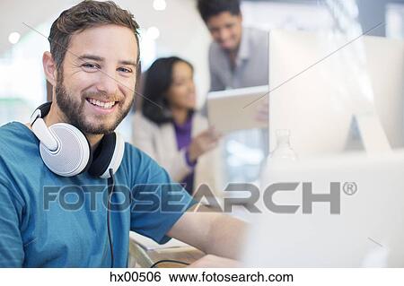 Portrait confident creative businessman with headphones working in office View Large Photo Image Stock Photograph - Portrait confident creative businessman with headphones working in office. Fotosearch