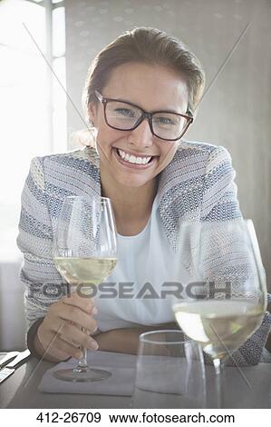 Portrait confident woman with eyeglasses drinking white wine View Large Photo Image Stock Photo - Portrait confident woman with eyeglasses drinking white wine. Fotosearch