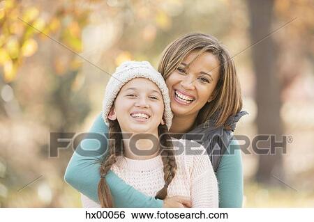 Portrait enthusiastic mother and daughter hugging outdoors View Large Photo Image Stock Photograph - Portrait enthusiastic mother and daughter hugging outdoors. Fotosearch