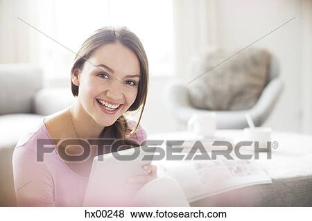 Stock Photo - Portrait of enthusiastic woman with digital tablet. Fotosearch