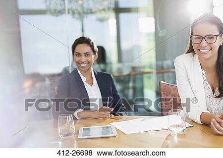 Portrait smiling businesswomen in conference room View Large Photo Image Stock Photo - Portrait smiling businesswomen in conference room. Fotosearch