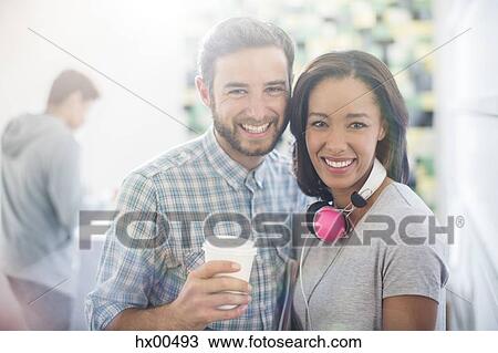 Portrait smiling creative business people with headphones and coffee View Large Photo Image Stock Image - Portrait smiling creative business people with headphones and coffee. Fotosearch