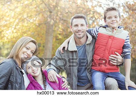 Portrait smiling family in front of tree with autumn leaves View Large Photo Image Stock Image - Portrait smiling family in front of tree with autumn leaves. Fotosearch