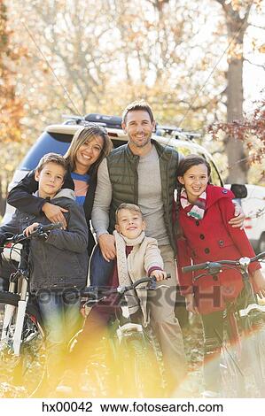 Portrait smiling family with mountain bikes outdoors View Large Photo Image Stock Image - Portrait smiling family with mountain bikes outdoors. Fotosearch