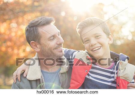 Portrait smiling father and son in front of autumn leaves View Large Photo Image Stock Photograph - Portrait smiling father and son in front of autumn leaves. Fotosearch
