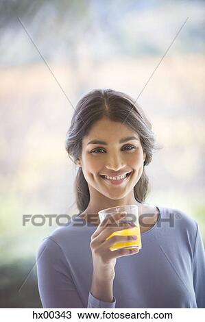 Portrait smiling woman drinking orange juice View Large Photo Image Stock Image - Portrait smiling woman drinking orange juice. Fotosearch