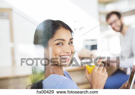 Portrait smiling woman drinking orange juice View Large Photo Image Stock Photo - Portrait smiling woman drinking orange juice. Fotosearch