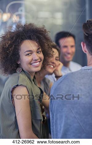 Portrait smiling woman hanging out with friends View Large Photo Image Stock Image - Portrait smiling woman hanging out with friends. Fotosearch