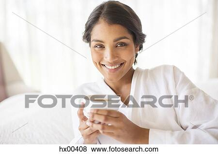 Portrait smiling woman in bathrobe drinking tea View Large Photo Image Stock Photo - Portrait smiling woman in bathrobe drinking tea. Fotosearch