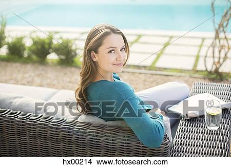 Portrait smiling woman reading magazine at luxury poolside View Large Photo Image Picture - Portrait smiling woman reading magazine at luxury poolside. Fotosearch